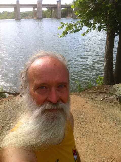 Taiji beach on the shore of Lady Bird Lake in Austin Texas, with Longhorn Dam in the background